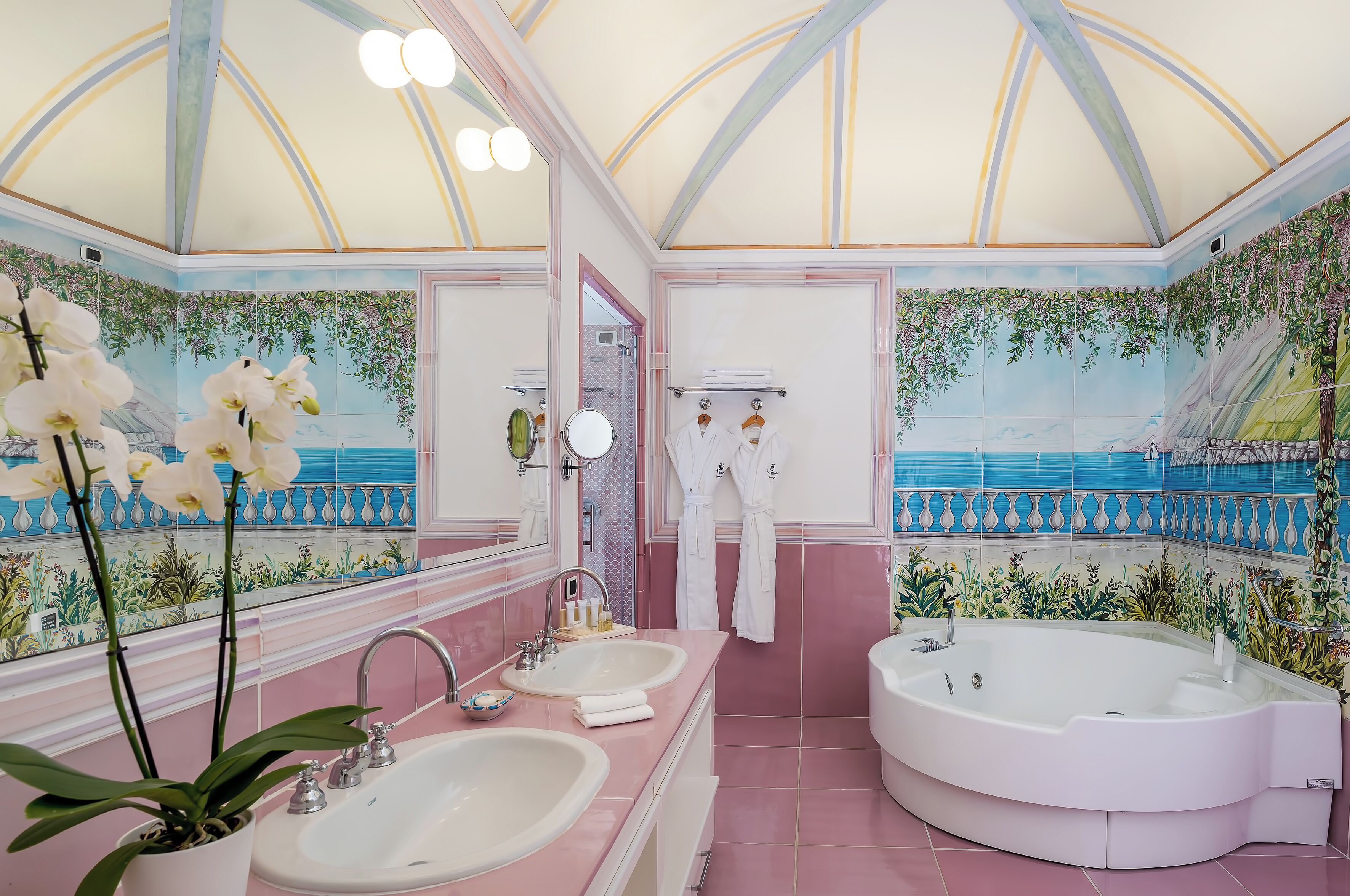 A luxurious bathroom with a large bathtub, two sinks, and a mirror.