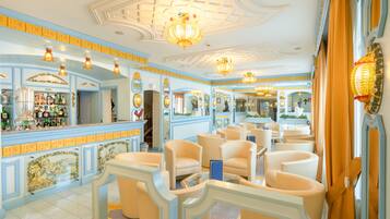 A hotel lobby with a bar area, seating, and decorative elements.