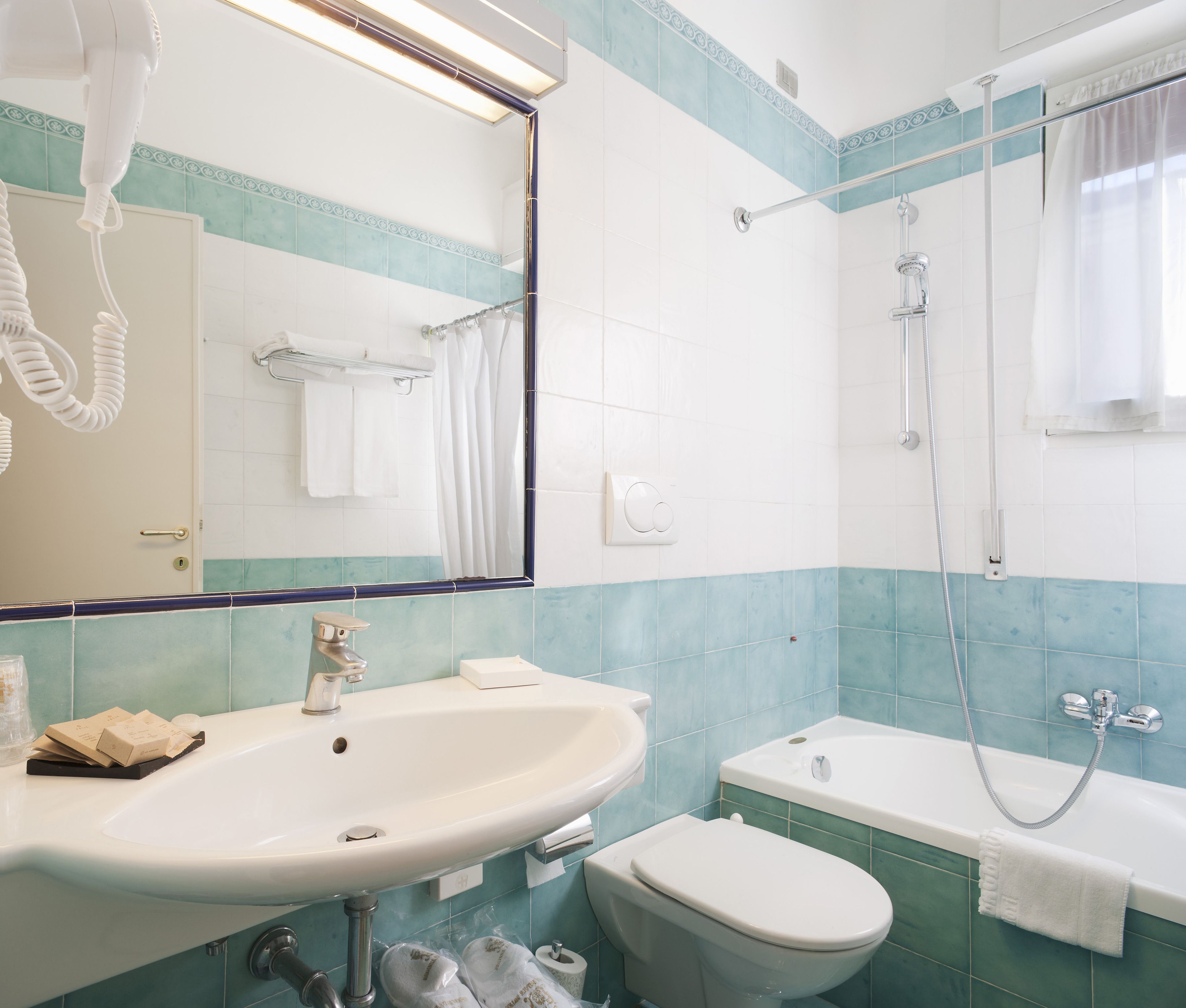 A bathroom with a sink, toilet, and bathtub.