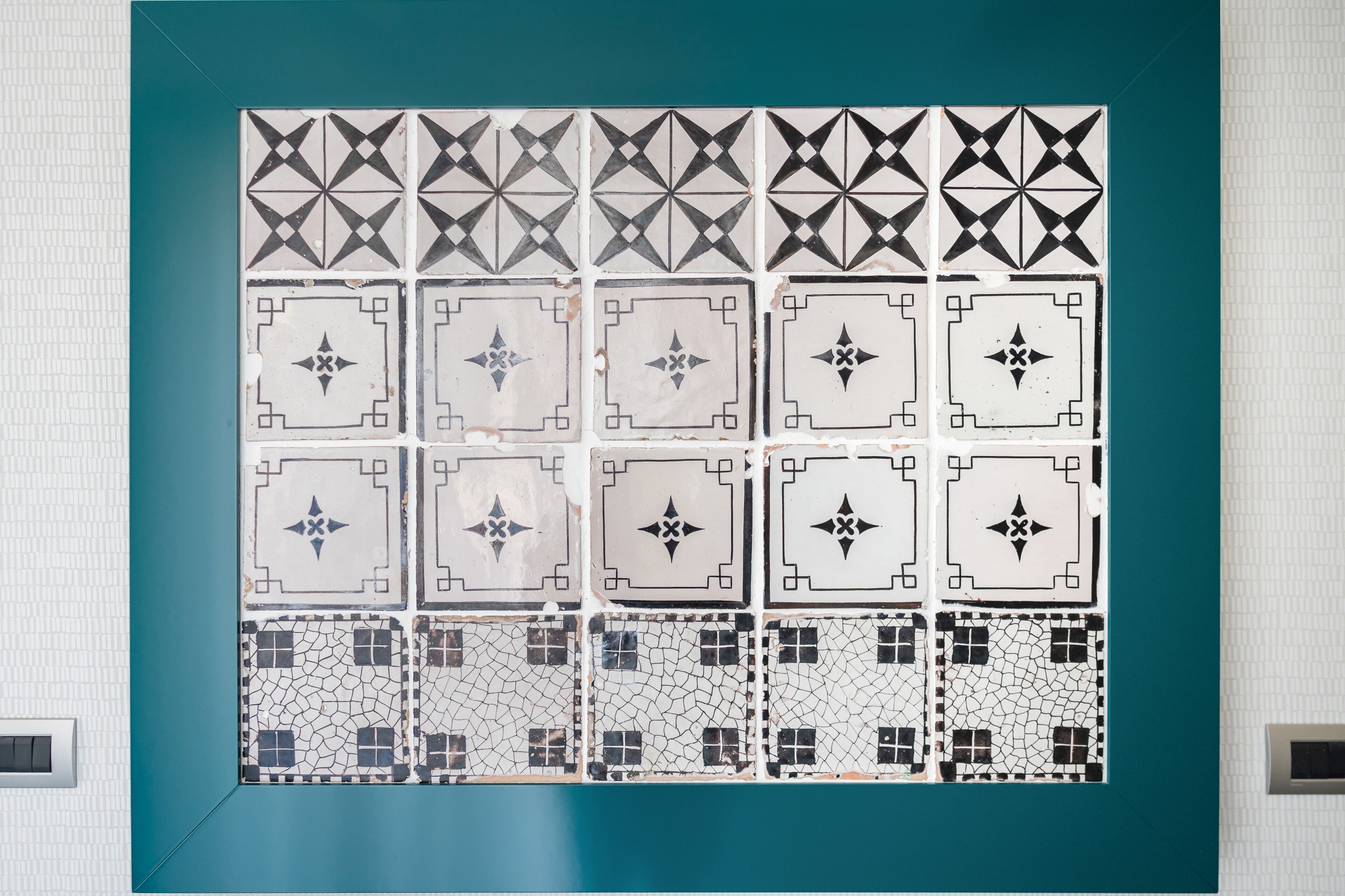 A tiled wall with a geometric pattern.