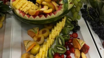 A fruit platter with a variety of fruits including watermelon, grapes, strawberries, kiwi, and pineapple.