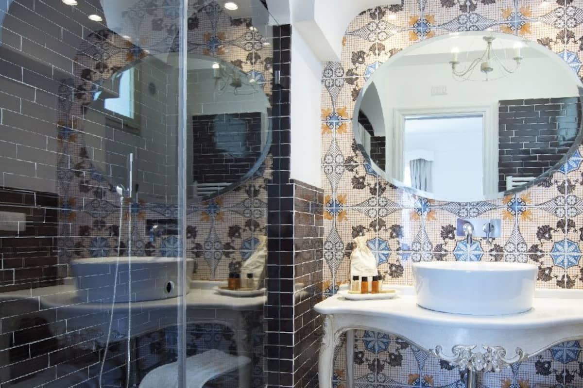 junior suite | bathroom | shower, hair dryer, bathrobes, slippers