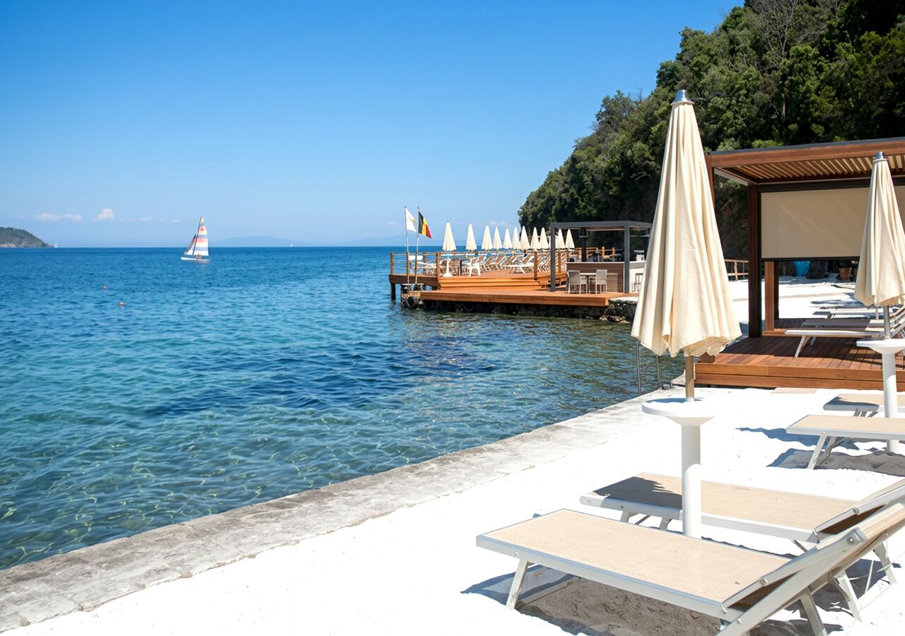 Privat strand, solsenger, parasoller og strandbar
