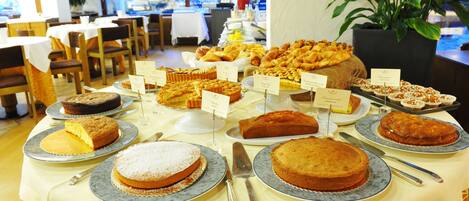 Una mesa de buffet con diversos pasteles y dulces.