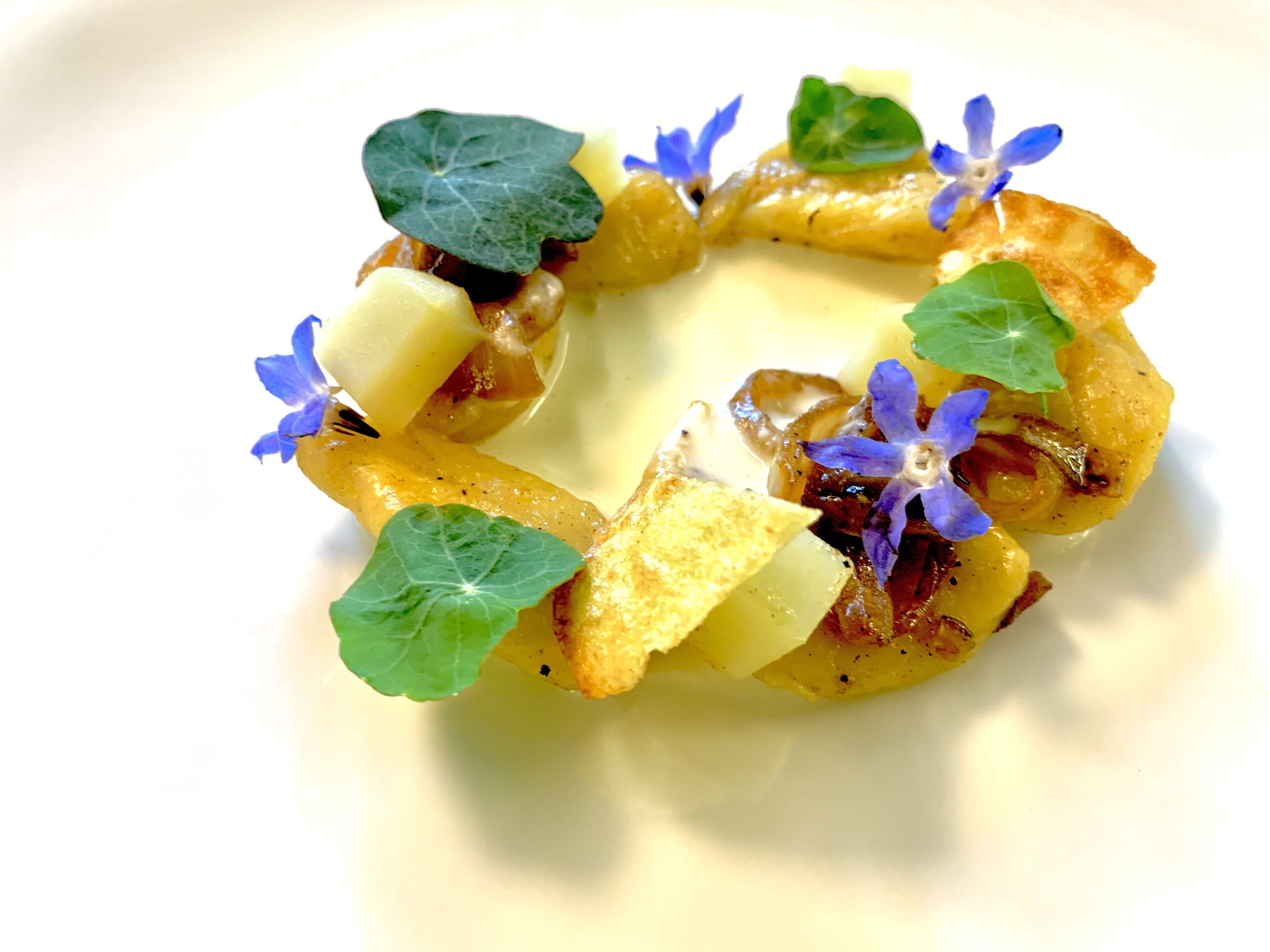 A plated dish with a variety of food items and garnishes.