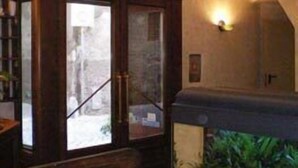 A room with a wooden cabinet, a fish tank, and a staircase. - Hotel Valentino (Orvieto)