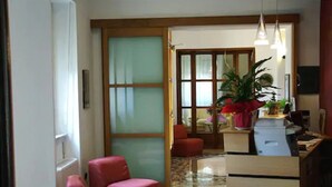 A room with a desk, chair, and a large window with a view. - Hotel Paradiso (Spoleto)
