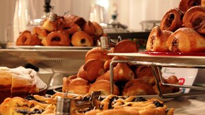 A buffet with various pastries and desserts.