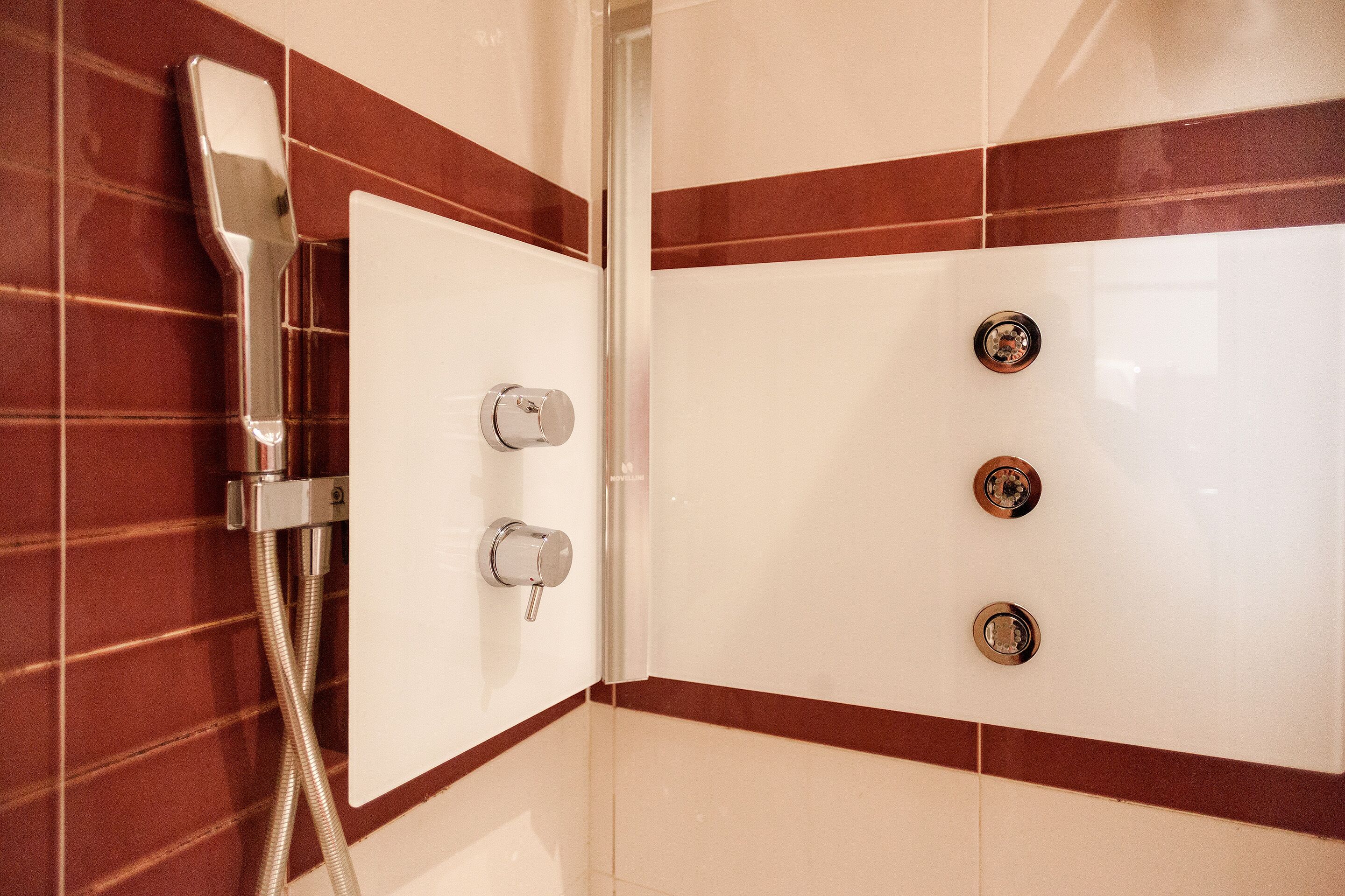 A bathroom with a shower, a toilet, and a sink.