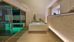A modern bathroom with a glass-enclosed shower, a large bathtub, and a mosaic wall. - Best Western Premier Milano Palace Hotel (Modena)
