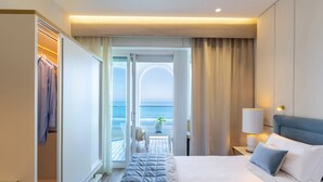 A hotel room with a bed, a nightstand, a lamp, a view of the ocean, and a closet. - Tiffany's (Riccione)