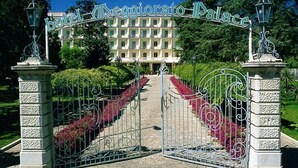 A gated entrance to Hotel D'eggiorato Palace with a clear pathway leading to the building.