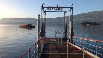 A pier with a sign reading "ASIAN" and a boat in the background.
