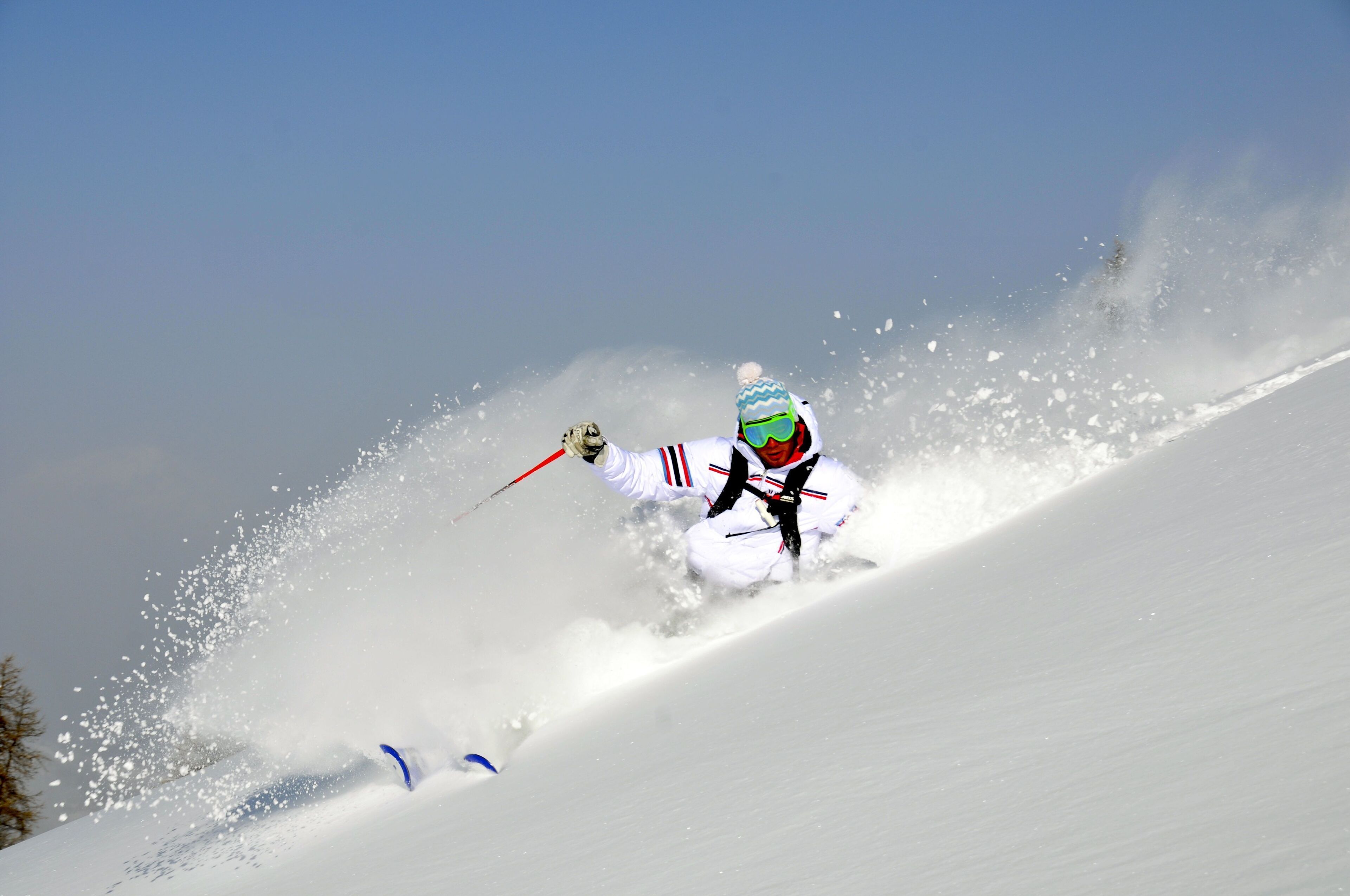 A skier in motion on a snowy slope.