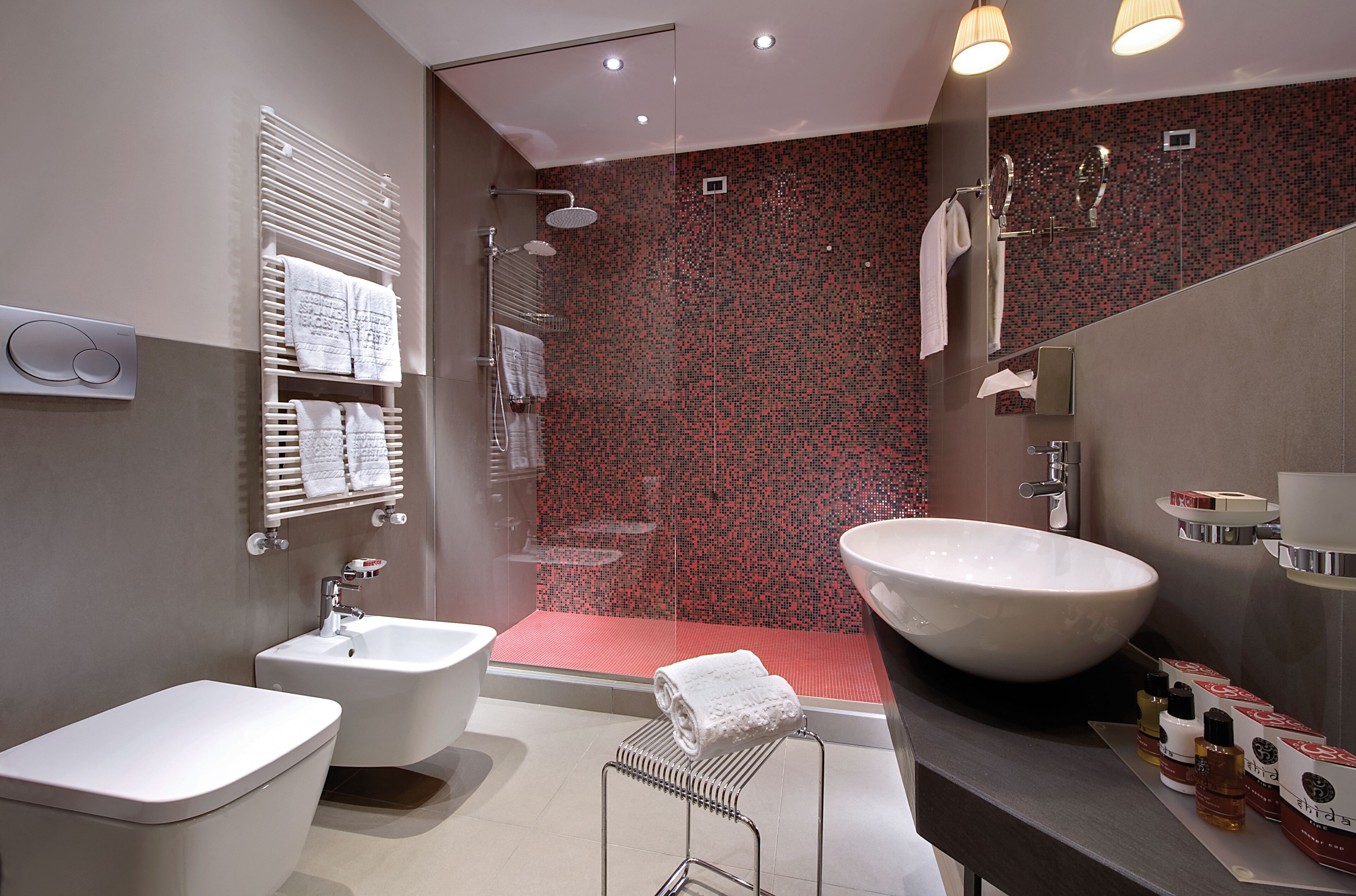 A modern bathroom with a large sink, bidet, and shower.