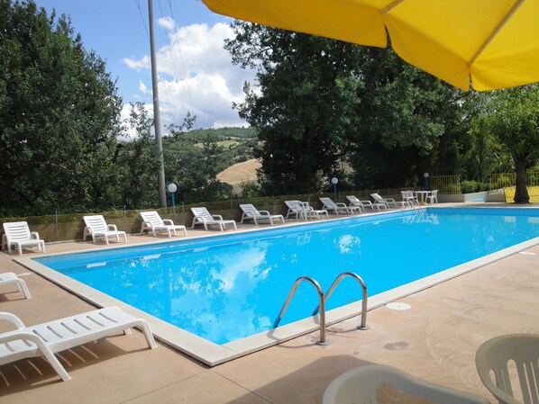 Seasonal outdoor pool, pool umbrellas, pool loungers