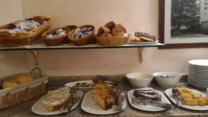 A breakfast buffet with various pastries, cakes, and fruits. - Hotel Cecchin (Aosta)
