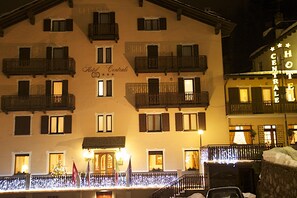 A hotel with multiple balconies, a sign reading "Hotel Centrale," and a well-lit facade. - Centrale (Courmayeur)