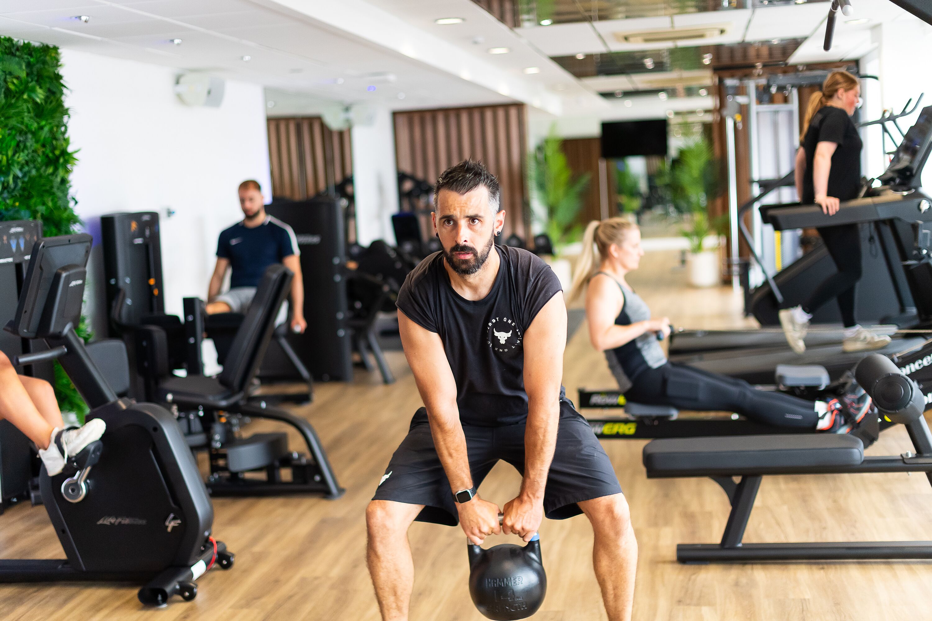 A gym with exercise equipment, including treadmills and weight machines.