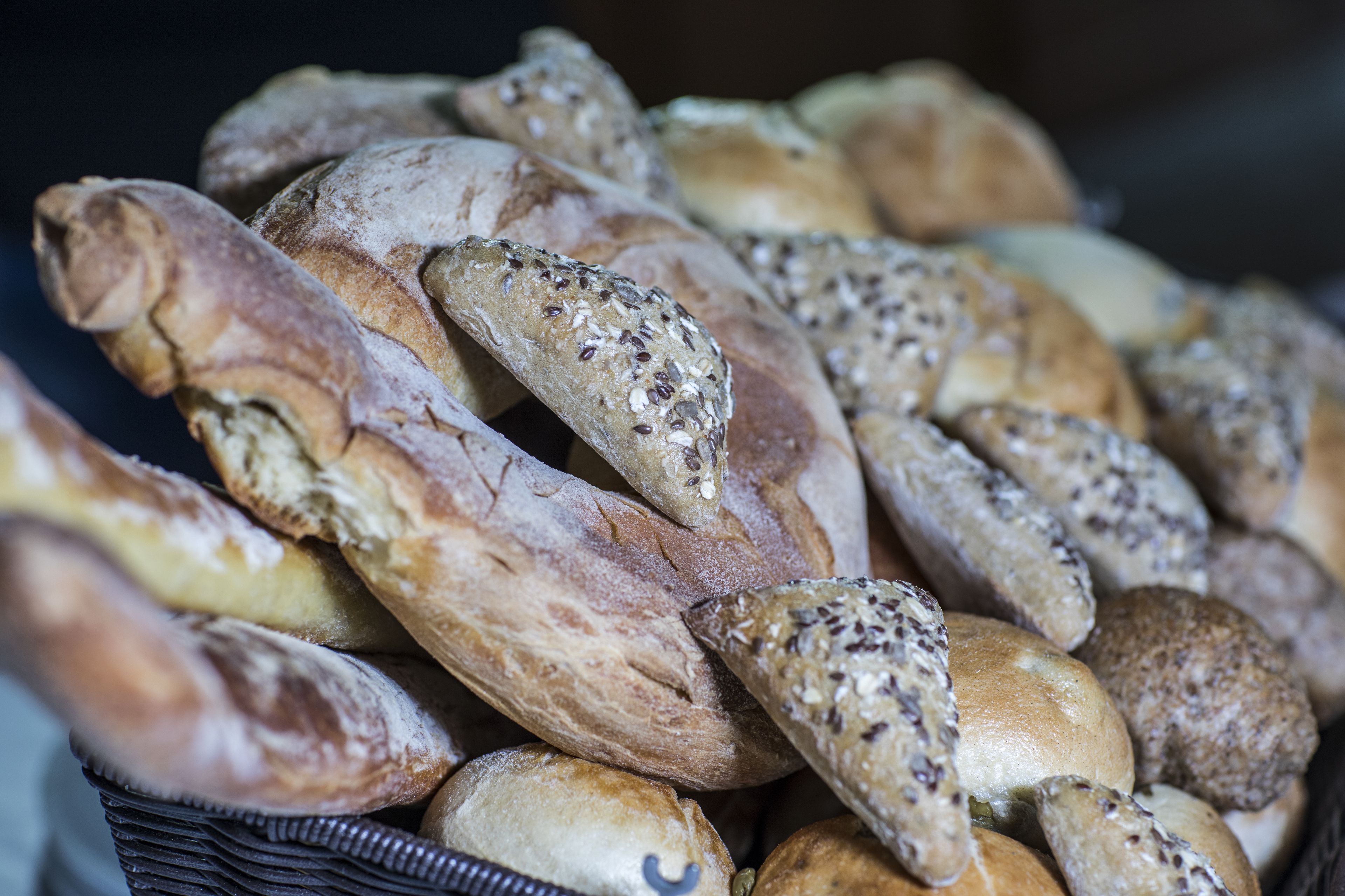 A variety of breads with different textures and seeds.