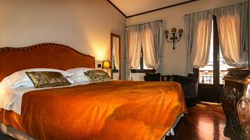 A large bed with a wooden headboard, two bedside lamps, and a nightstand.