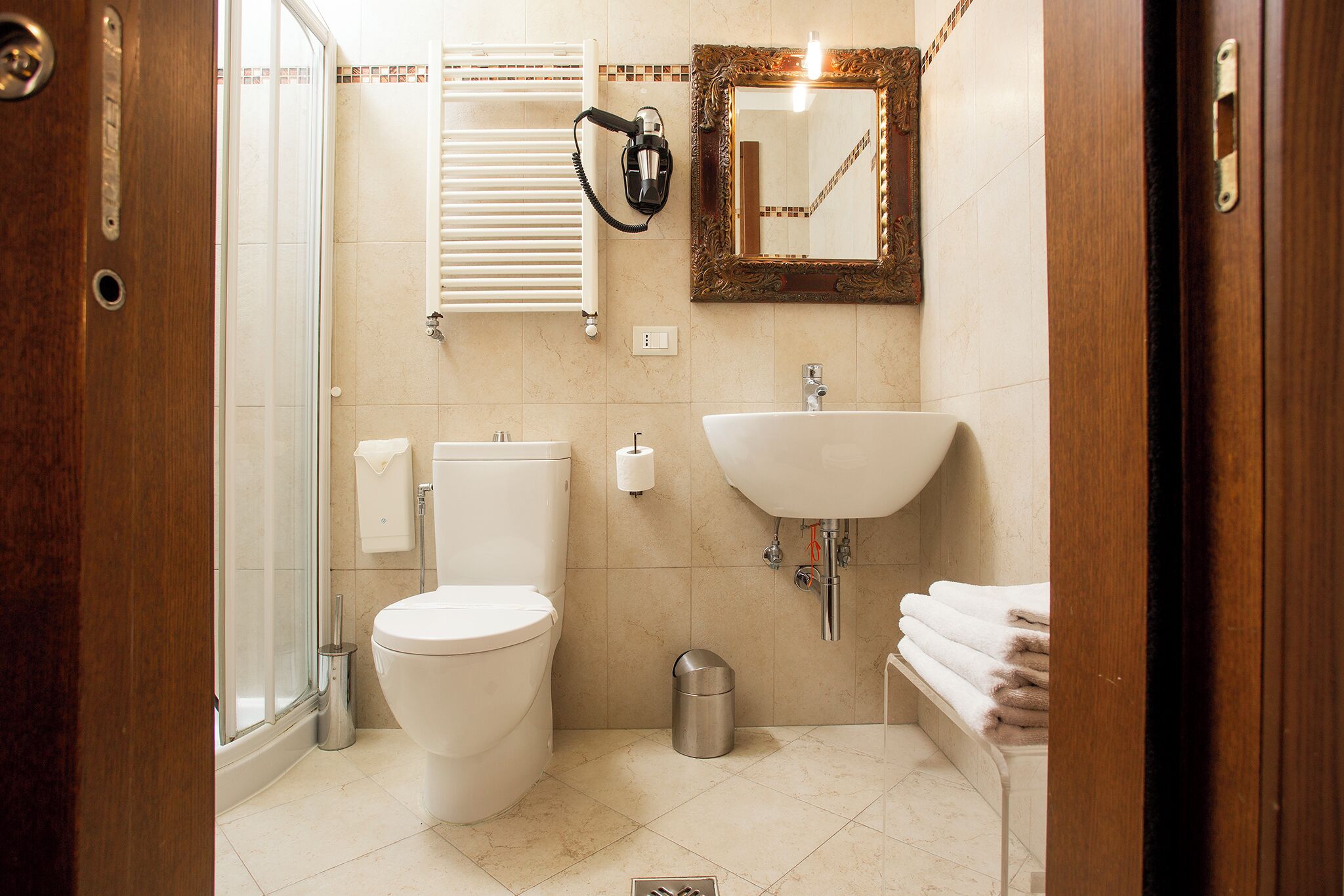 A modern bathroom with a toilet, sink, and shower.