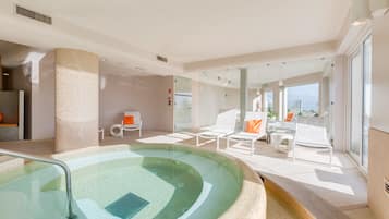 Relax by the pool surrounded by a glass barrier and comfortable lounge chairs.