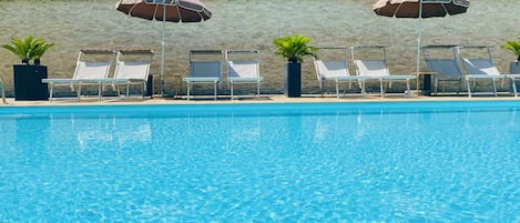 Seasonal outdoor pool, open 8:30 AM to 7:30 PM, pool umbrellas