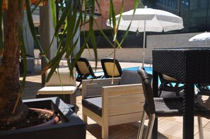 Seasonal outdoor pool, open 8:30 AM to 7:30 PM, pool umbrellas