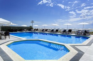 Piscine extérieure, parasols de plage, chaises longues