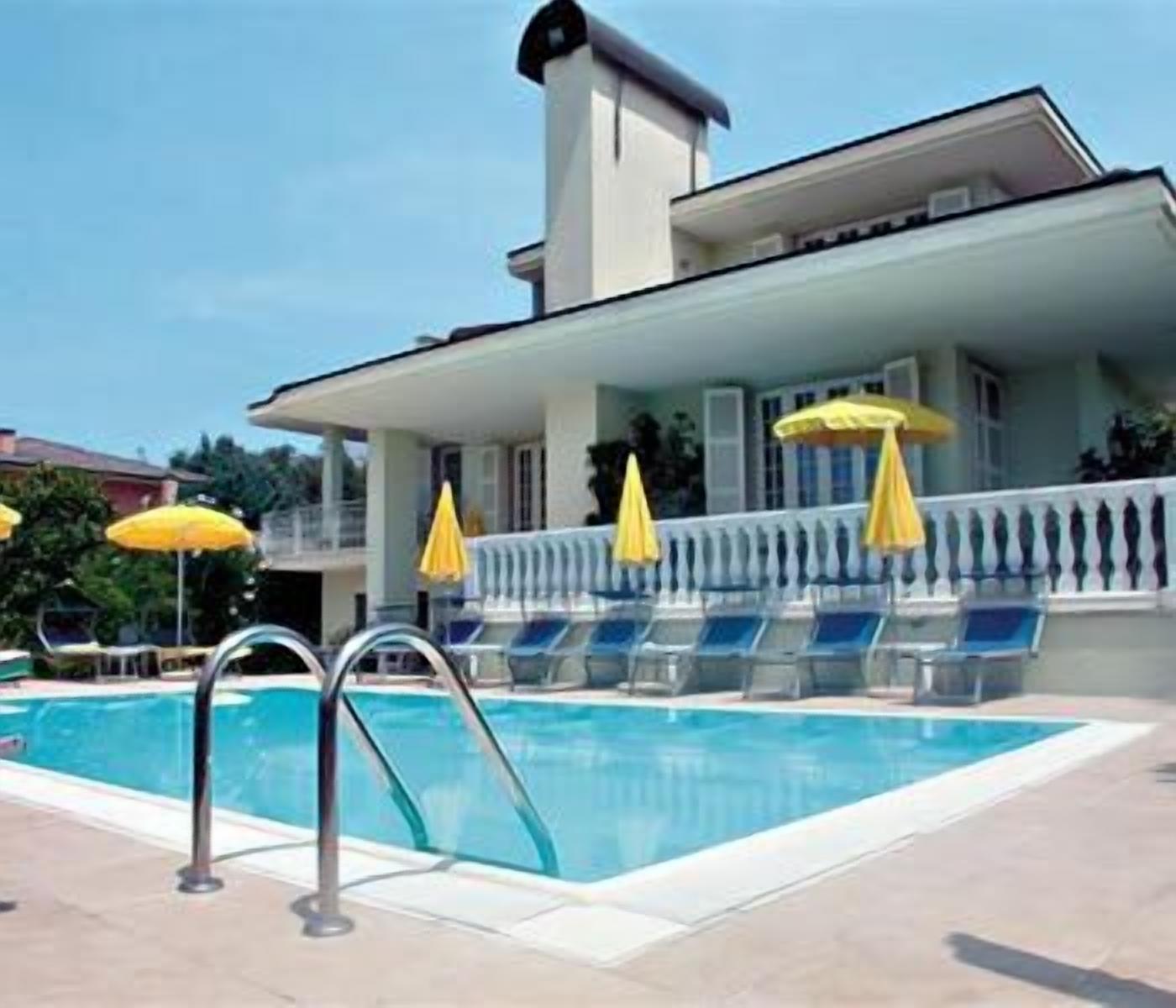 outdoor pool, an infinity pool, pool umbrellas, pool loungers