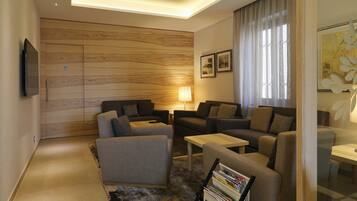 A modern living room with sofas, a coffee table, and a TV.