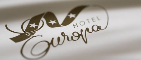A logo with the text "Hotel Europa" on a white background.