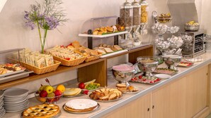 A buffet with various food items, including pastries, fruits, and beverages. - Hotel dei Mille (Rome)