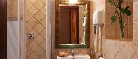 A bathroom with a shower, sink, and mirror.