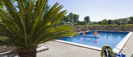 Seasonal outdoor pool, pool loungers