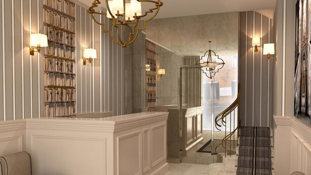 A grand hallway with a marble floor, a staircase, and a seating area with upholstered chairs. - Hotel Bartolomeo (Venice)