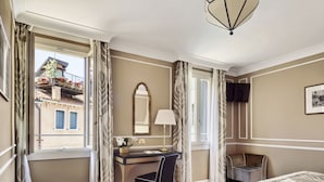 A hotel room with a bed, a desk with a chair, a TV, and a window with curtains. - Hotel Al Nuovo Teson (Venice)