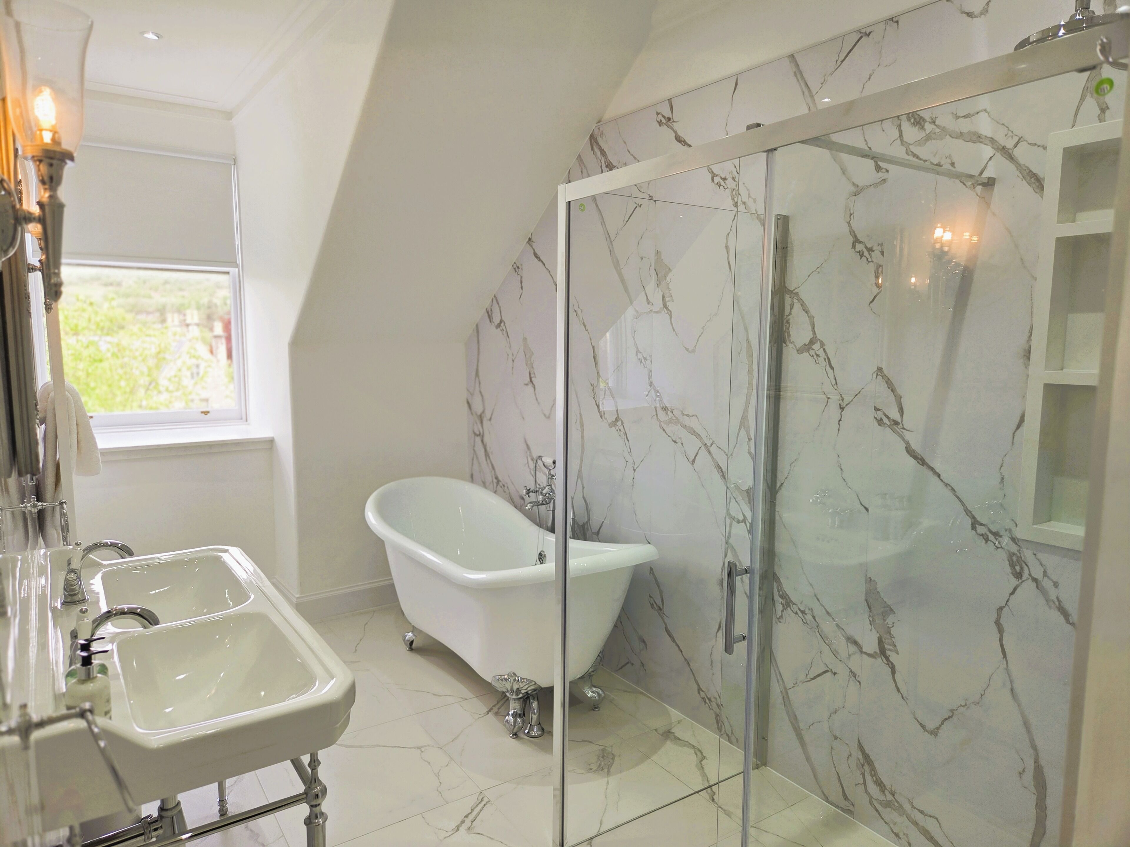 A bathroom with a freestanding bathtub, a glass-enclosed shower, and a sink with a mirror.
