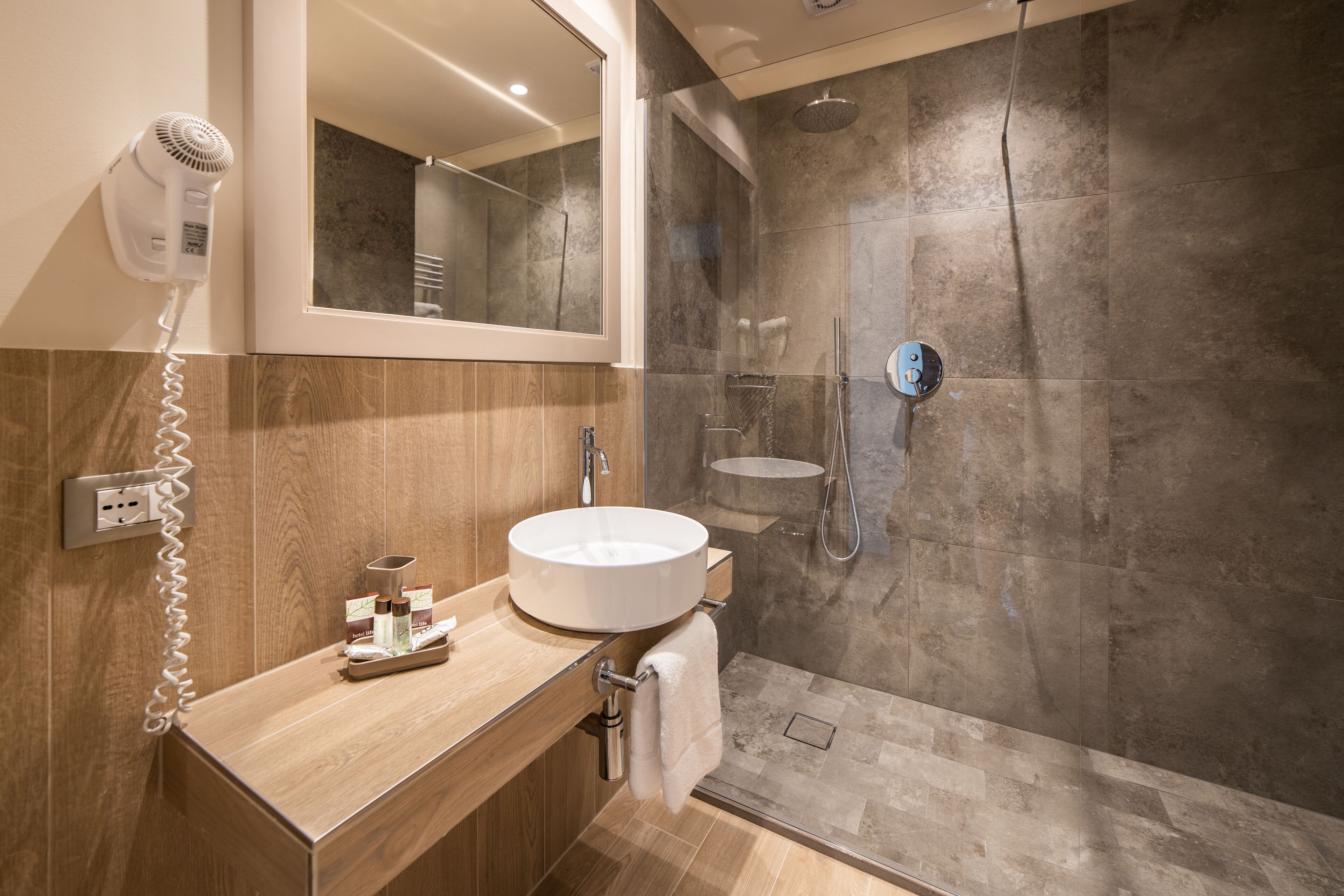 superior triple room | bathroom | rainfall showerhead, hair dryer, bidet, towels