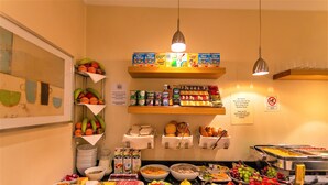 A buffet with various food items, including fruits, cheeses, and breads. - The Sumner (London)