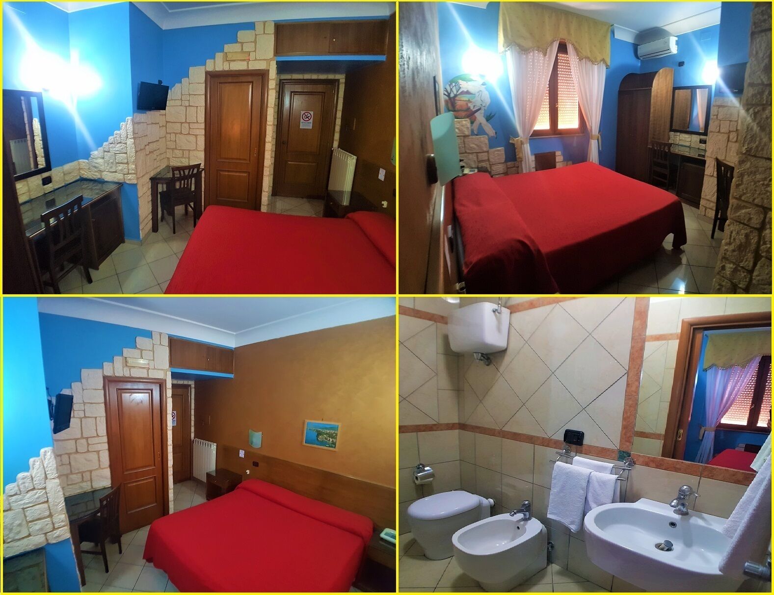 A hotel room with a red bed, a stone wall, a wooden door, a TV, and a bathroom with a bidet and sink.