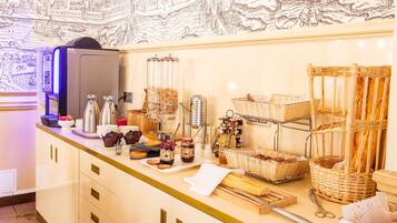 A breakfast buffet with various food items, a coffee machine, and wicker baskets.