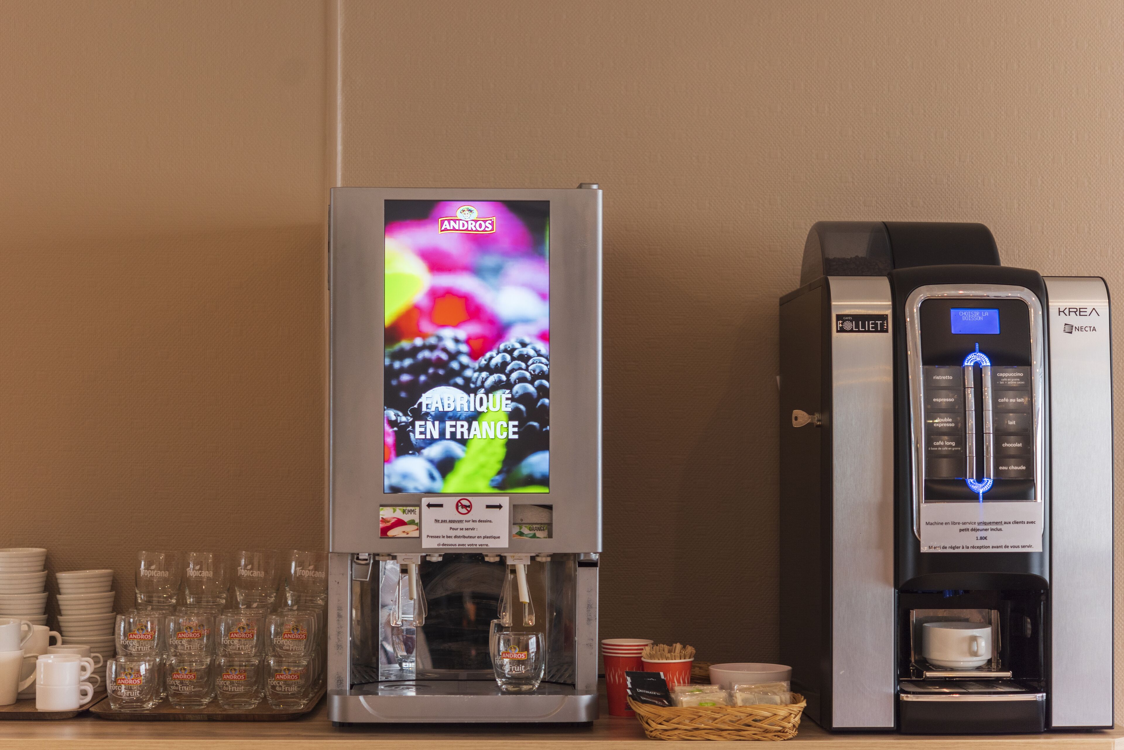 A coffee machine with a digital display and a water dispenser.