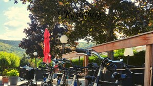 Bicycles parked in an outdoor area with a view of the hills. - The Originals Boutique, Hotel Le Kastelberg (Andlau)