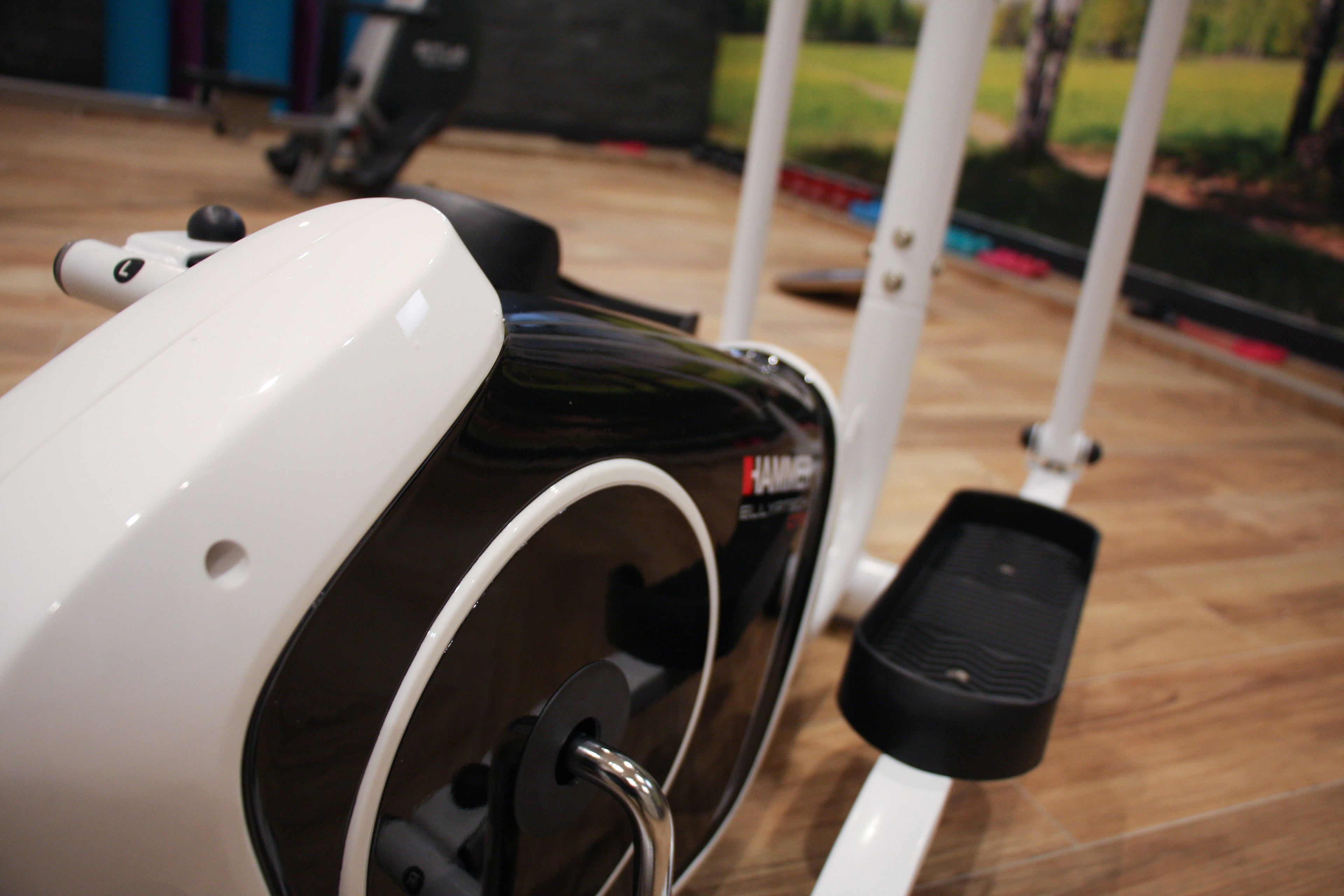 A stationary exercise bike with a control panel and a foot pedal.