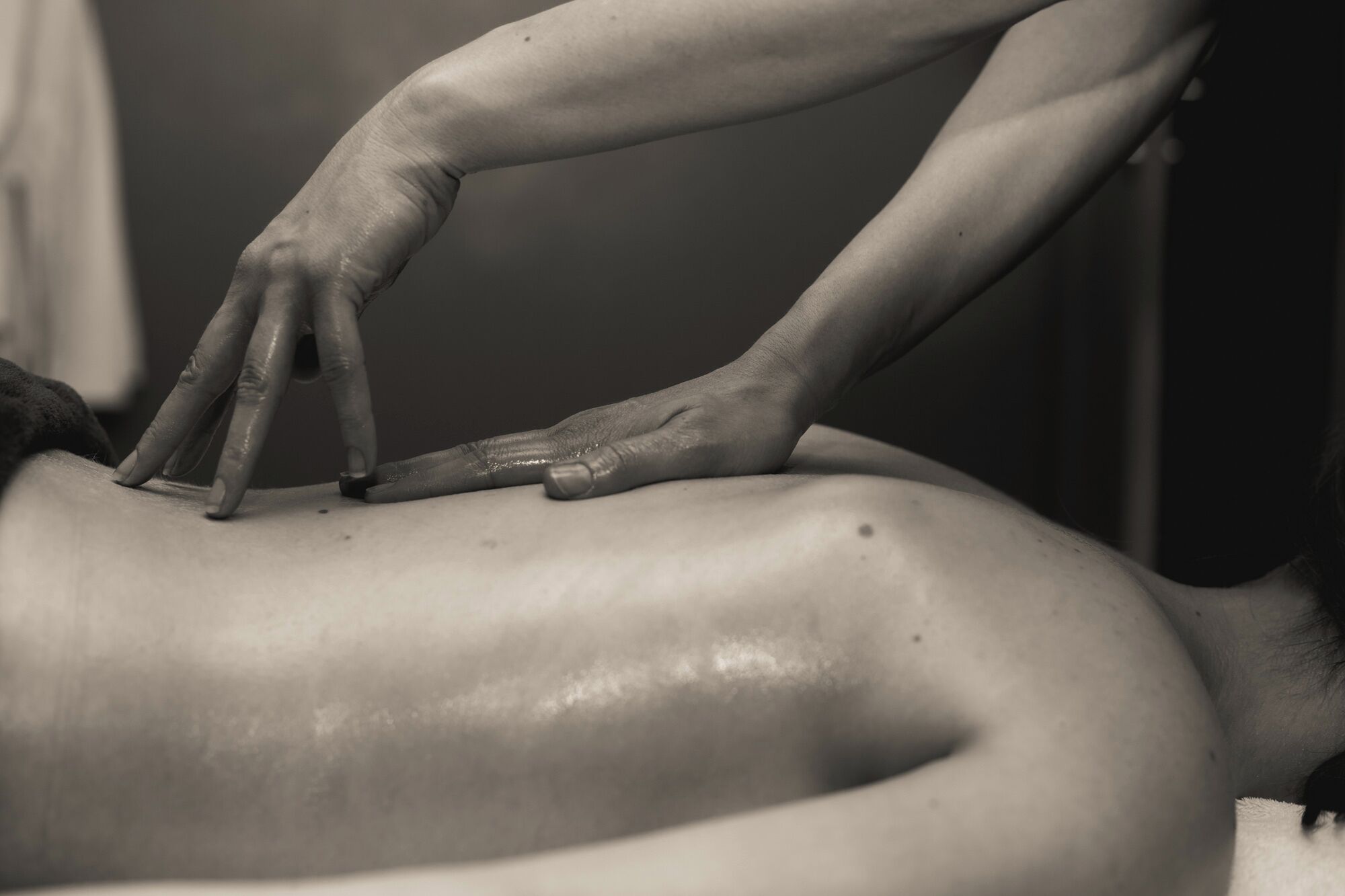 A person receiving a massage on a massage table.