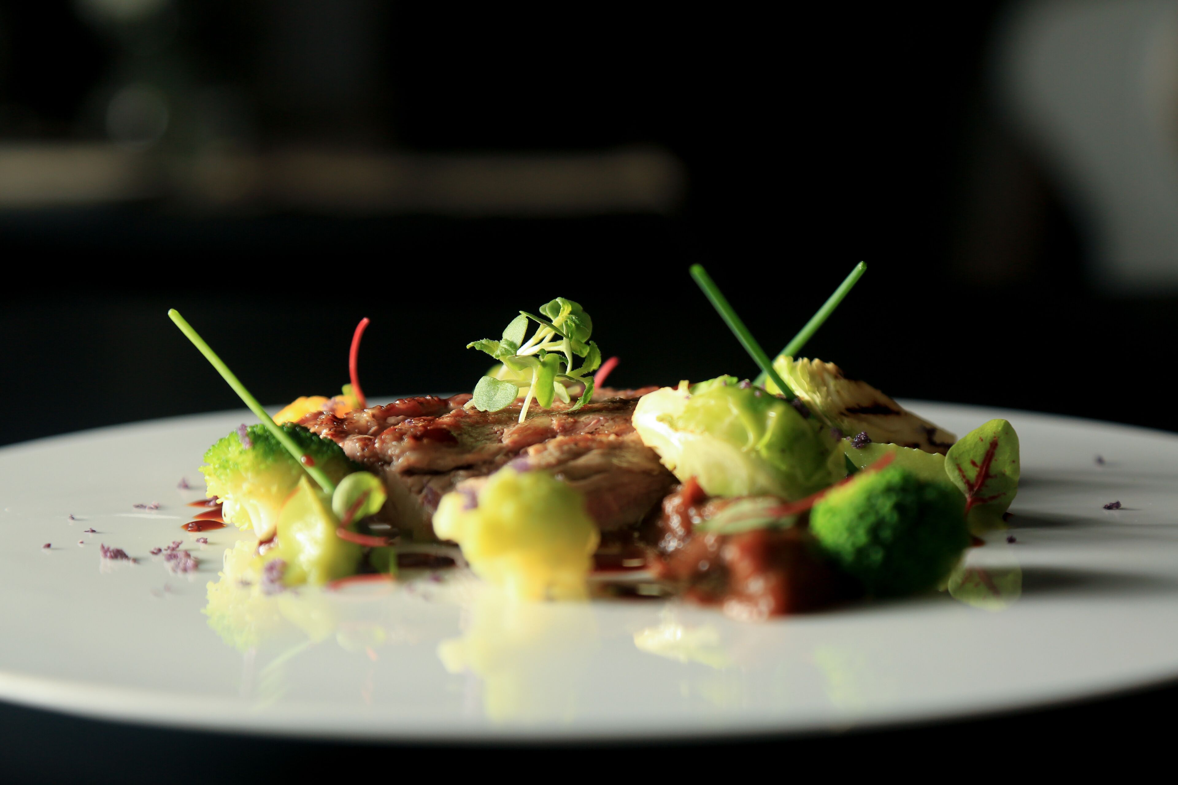 A plate of food with various vegetables and a sauce.