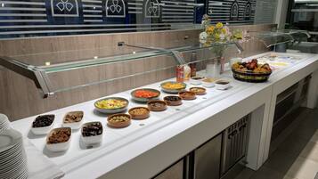 A buffet area with various food options and a glass display case.
