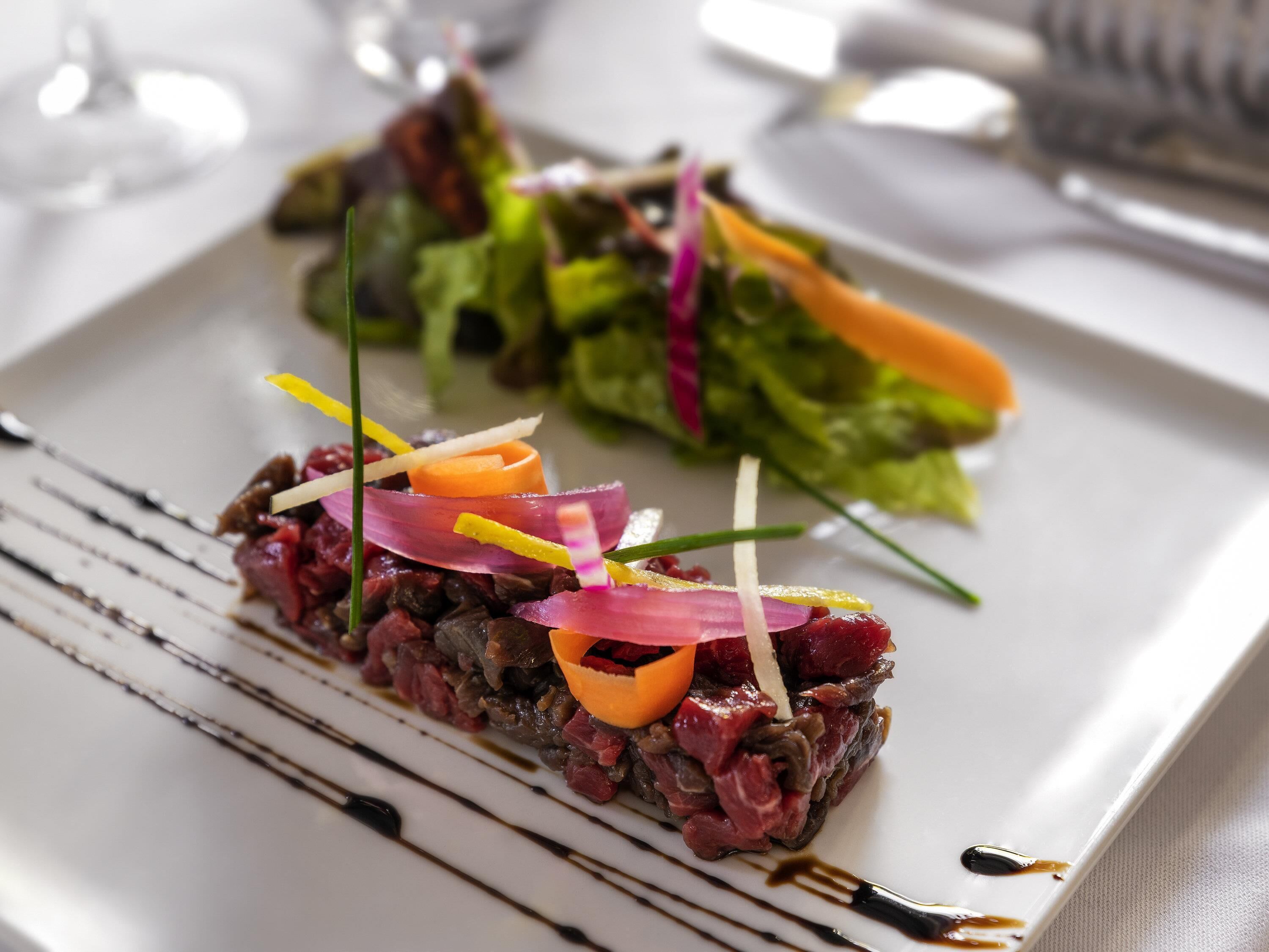 A plate of food with a variety of garnishes and sauces.